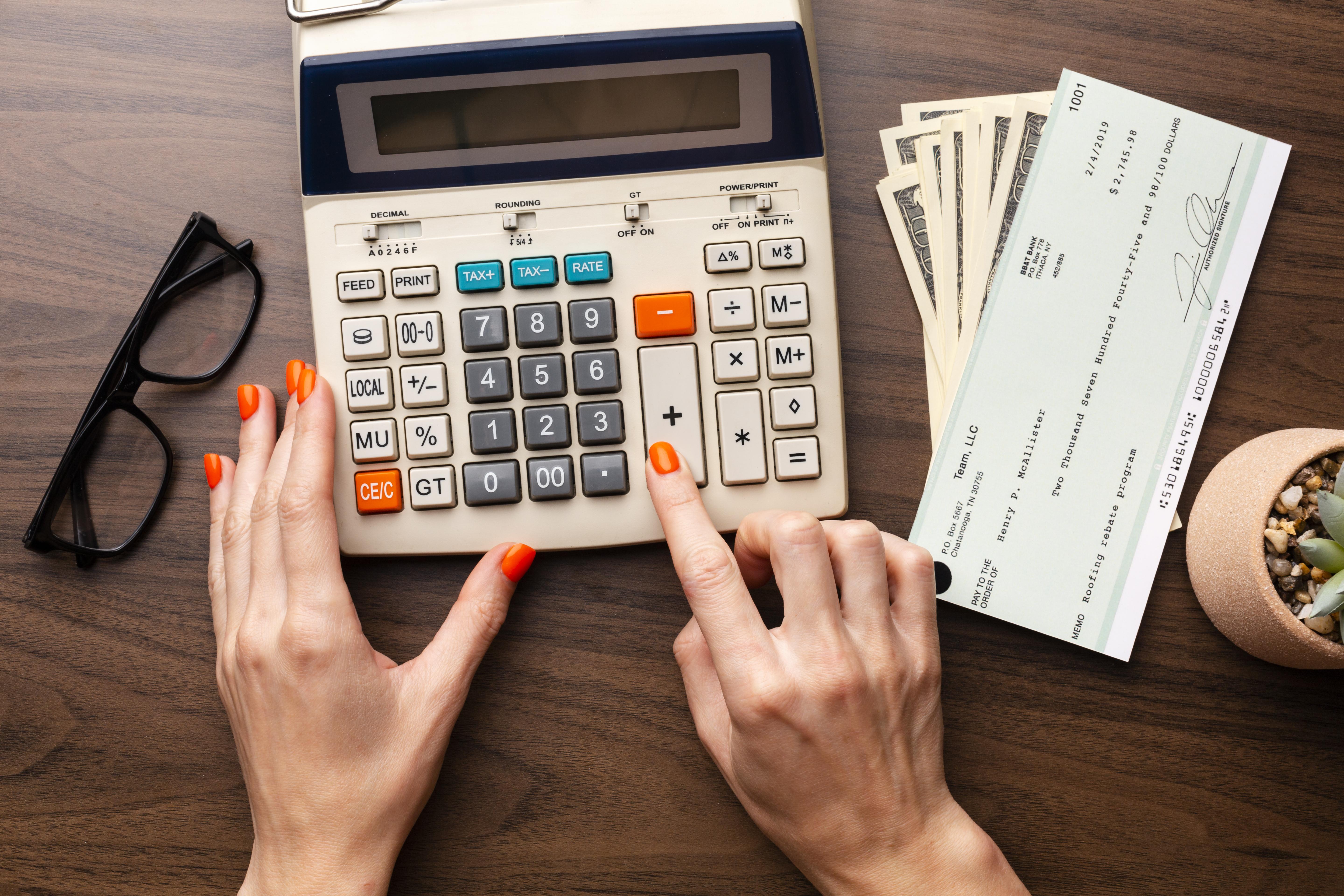 close-up-hands-using-calculator